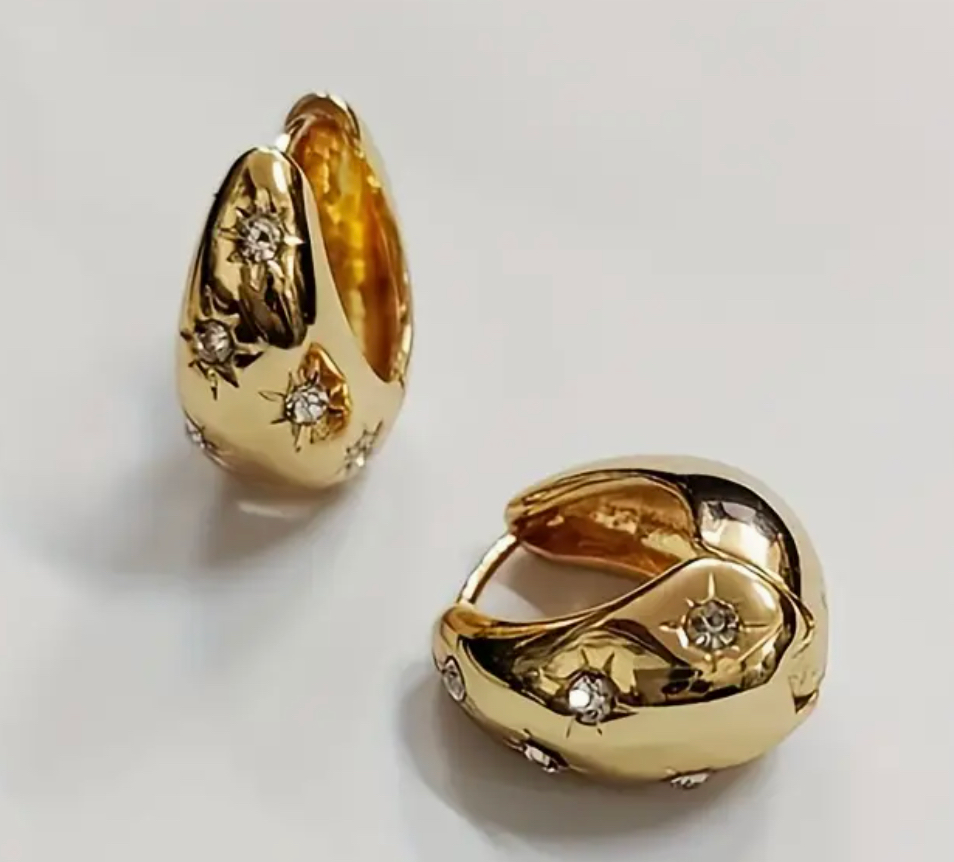 Gold drop star earrings with 18k gold plating and cubic zirconia.