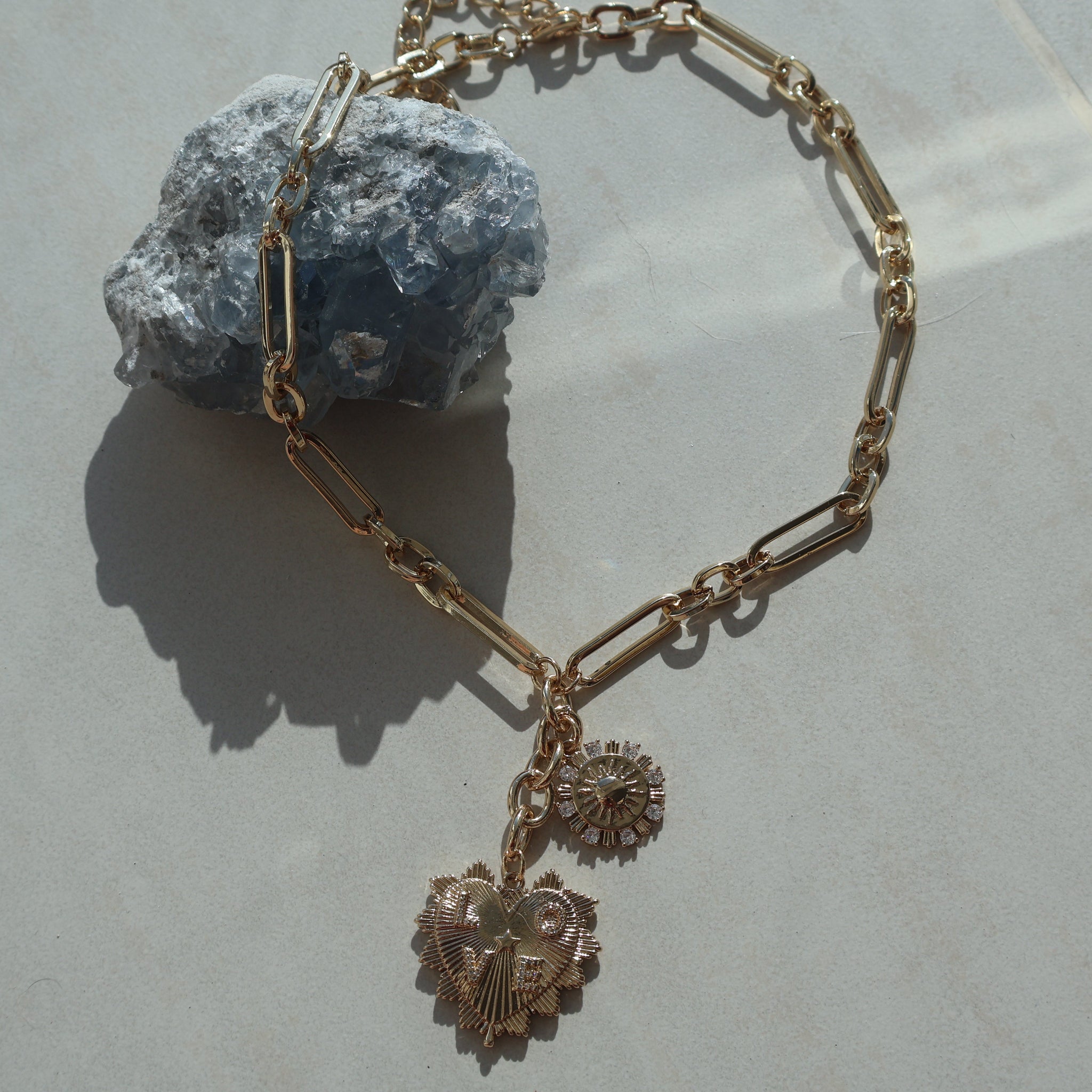 Gold Heart Love Necklace with sun pendant and cubic zirconia on a paperclip chain.
