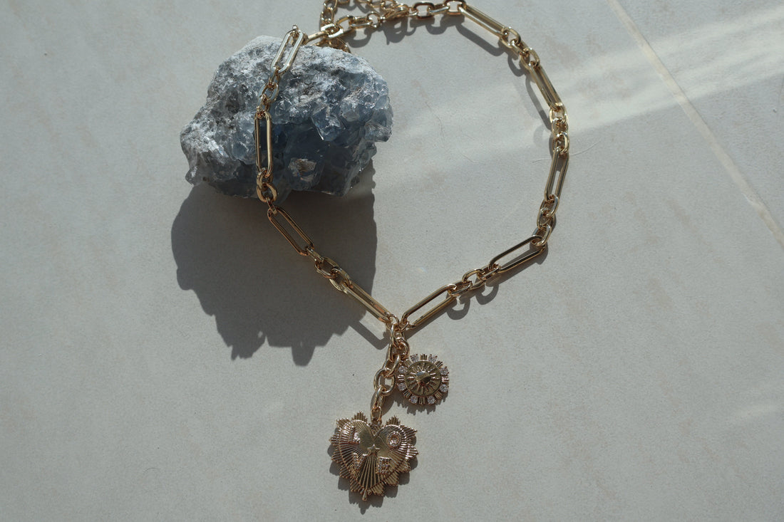 Gold Heart Love Necklace with sun pendant and cubic zirconia on a paperclip chain.