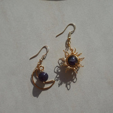 Gemstone Sun and Moon earrings with intricate wire-wrapped celestial designs and sparkling crystals.