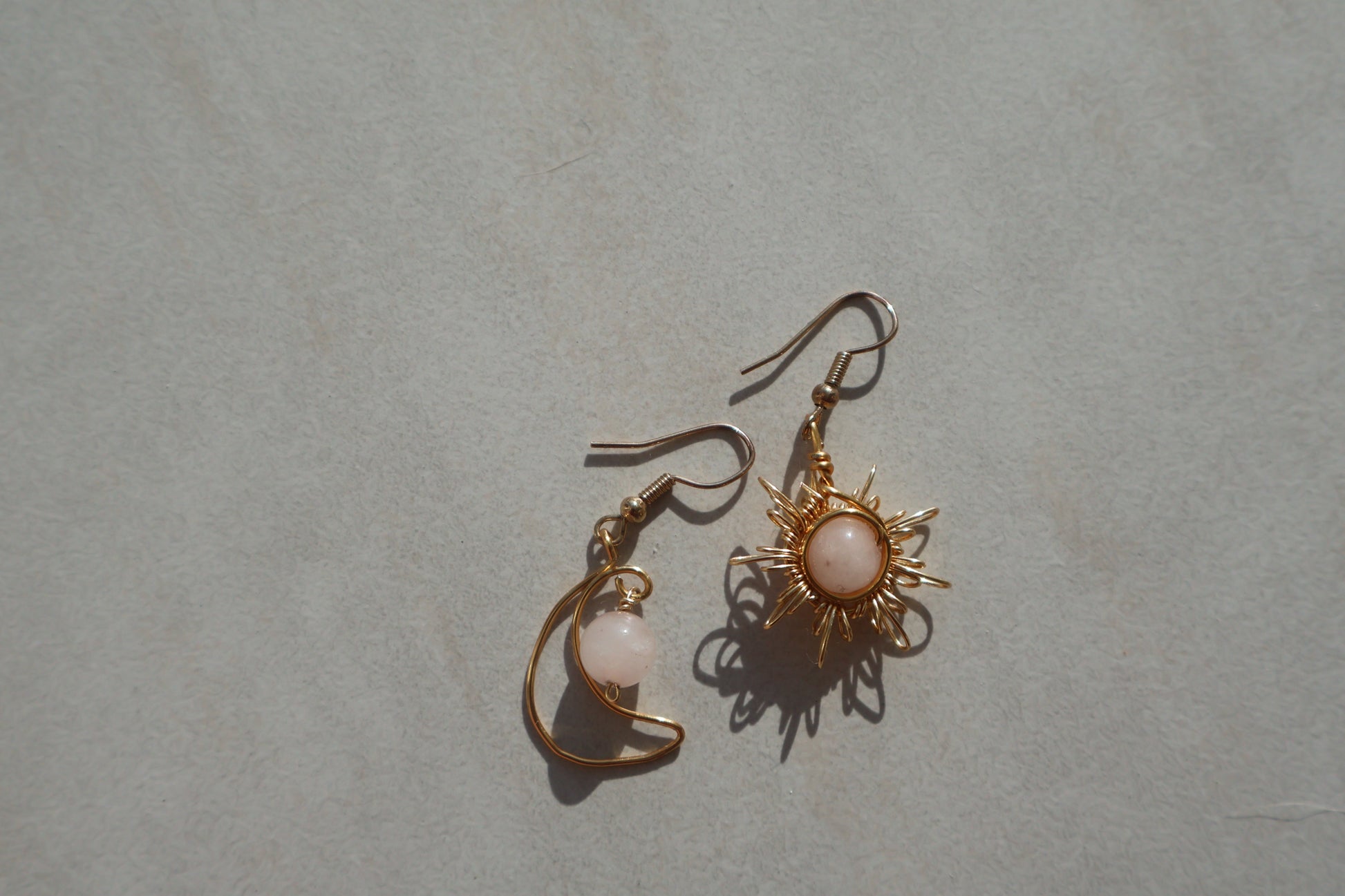 Gemstone Sun and Moon earrings with gold wire-wrapping and crystal accents.