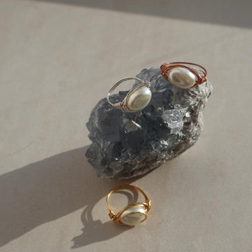 Sterling silver baroque pearl statement ring with unique freshwater pearl design on rock display.