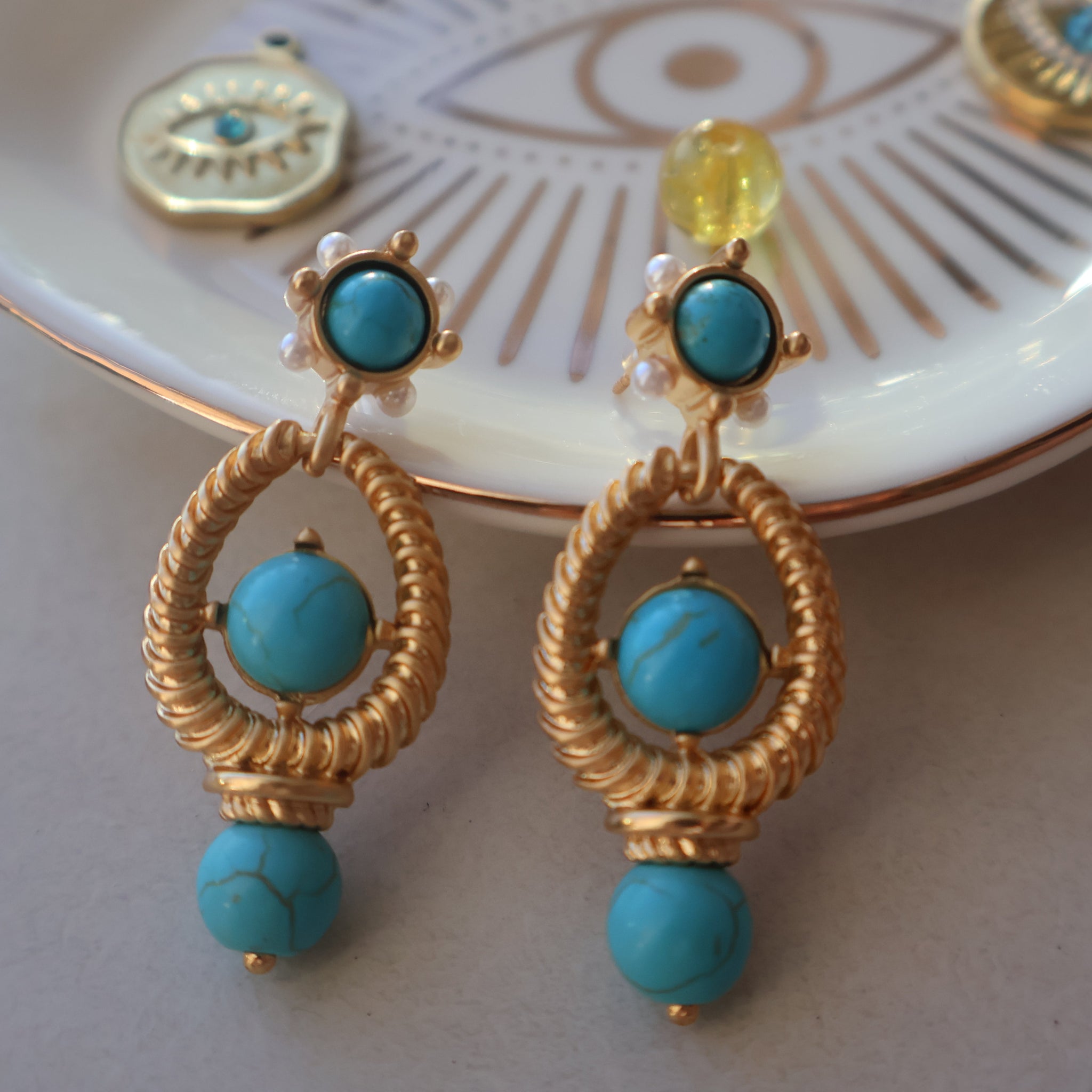 Turquoise vintage style earrings with natural turquoise beads and gold-plated design.