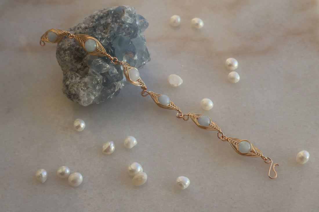 Handmade Aquamarine Herring Bone Bracelet with genuine aquamarine stones and pearls on a light background.