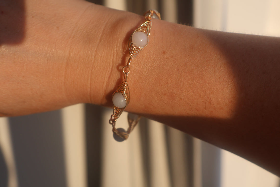 Handmade Aquamarine Herring Bone Bracelet with genuine aquamarine stones and pearls on a light background.