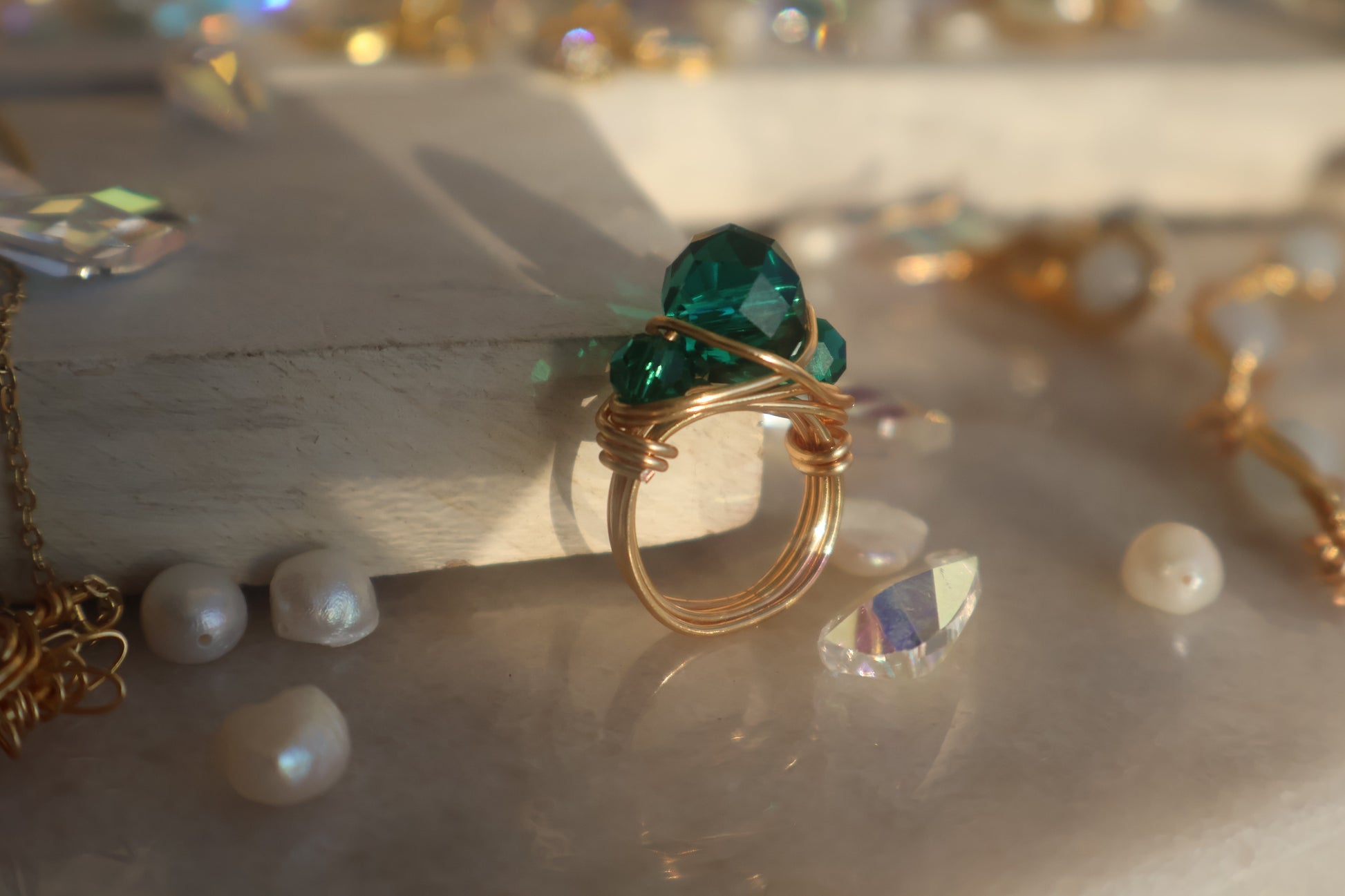 Gold emerald green bead ring with handcrafted copper wire wrap design.