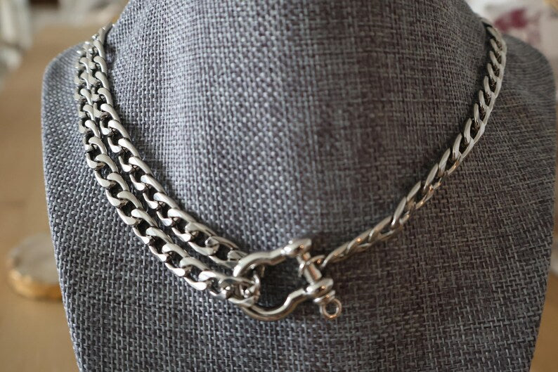 Silver Cuban link necklace on display bust.